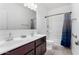 Bathroom featuring double sinks, a large mirror, and a shower with a blue curtain at 28259 N Chalcocite St, San Tan Valley, AZ 85143