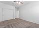 Bedroom with neutral colored carpet, ceiling fan, closet, and white walls at 28259 N Chalcocite St, San Tan Valley, AZ 85143