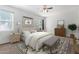 Relaxing bedroom with a plush bed, decorative rug, modern lighting, and a ceiling fan for added comfort at 28259 N Chalcocite St, San Tan Valley, AZ 85143