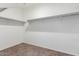 Walk-in closet offers wall mounted clothes rods and carpet floors at 28259 N Chalcocite St, San Tan Valley, AZ 85143