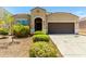 Inviting single-story home featuring a well-maintained yard, a dark front door and attached garage at 28259 N Chalcocite St, San Tan Valley, AZ 85143
