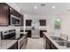 This kitchen offers stainless steel appliances, granite counters, dark cabinetry and tile flooring at 28259 N Chalcocite St, San Tan Valley, AZ 85143