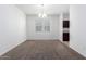 Open-concept living room with carpet flooring, chandelier, and natural light at 28259 N Chalcocite St, San Tan Valley, AZ 85143