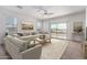 Spacious living room with a plush sectional sofa, stylish rug and sliding glass doors to the outside at 28259 N Chalcocite St, San Tan Valley, AZ 85143