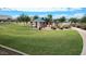 Enjoy a beautiful community park featuring lush grass, a playground, picnic benches, and walking paths at 28259 N Chalcocite St, San Tan Valley, AZ 85143