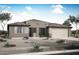 Charming single-story home with desert landscaping and a neutral color palette, complemented by a two-car attached garage at 28922 N 174Th Ln, Surprise, AZ 85387