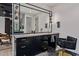 Bathroom vanity with sleek cabinetry, modern lighting, and a large mirror, creating a sophisticated space at 3425 N 50Th Pl, Phoenix, AZ 85018
