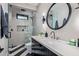 Luxurious bathroom with walk-in shower, modern fixtures, and elegant round mirror at 3425 N 50Th Pl, Phoenix, AZ 85018