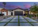 Modern driveway with concrete pavers separated by grass, leading to an attached garage at 3425 N 50Th Pl, Phoenix, AZ 85018