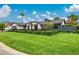 Beautiful home with lush green lawn, mature trees, and modern design elements on a sunny day at 3425 N 50Th Pl, Phoenix, AZ 85018