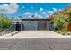 Modern home featuring a spacious driveway and a sleek, attached two car garage at 3425 N 50Th Pl, Phoenix, AZ 85018