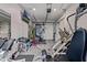 Spacious home gym with rubber flooring, garage door access, and modern fitness equipment at 3425 N 50Th Pl, Phoenix, AZ 85018