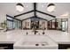 Farmhouse sink in an open-concept kitchen with high ceilings, exposed beams, and views into the living area at 3425 N 50Th Pl, Phoenix, AZ 85018