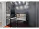Modern kitchen featuring stainless steel Wolf appliances, sleek black cabinets, and metallic tile backsplash at 3425 N 50Th Pl, Phoenix, AZ 85018