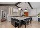 An open-concept kitchen features an oversized center island with chairs and professional grade appliances at 3425 N 50Th Pl, Phoenix, AZ 85018