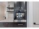 Built-in Dacor wine fridge with glass shelves and tile accents for easy access and storage at 3425 N 50Th Pl, Phoenix, AZ 85018