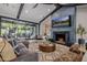 Spacious living room featuring a modern fireplace, comfortable seating, and access to the backyard at 3425 N 50Th Pl, Phoenix, AZ 85018