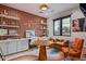 Colorful office space with custom built-ins, a decorative accent wall, and cozy seating area at 3425 N 50Th Pl, Phoenix, AZ 85018