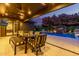 Under-covered outdoor dining space complete with string lights and overlooking pool at 3425 N 50Th Pl, Phoenix, AZ 85018