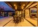 Under-covered outdoor dining area near the fireplace and sliding glass doors at 3425 N 50Th Pl, Phoenix, AZ 85018