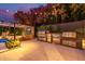 Well-appointed outdoor kitchen and bar area overlooking the patio, and pool, perfect for entertaining guests at 3425 N 50Th Pl, Phoenix, AZ 85018