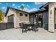 Covered patio with sleek dining table and chairs provides a comfortable outdoor dining space at 3425 N 50Th Pl, Phoenix, AZ 85018