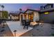 Stylish outdoor patio with a stone fire pit, seating, and views of the home's architecture at 3425 N 50Th Pl, Phoenix, AZ 85018