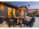 Elegant outdoor dining space on a patio with black furniture and a view of the home's exterior at 3425 N 50Th Pl, Phoenix, AZ 85018