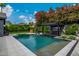 Inviting backyard pool with a swim up bar, a built-in spa, and lush landscaping at 3425 N 50Th Pl, Phoenix, AZ 85018