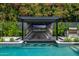 Charming poolside bar with underwater stools, covered pergola and outdoor kitchen at 3425 N 50Th Pl, Phoenix, AZ 85018