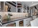 An elegant wine bar features a custom wine rack, beverage fridge and decorative tile backsplash at 3425 N 50Th Pl, Phoenix, AZ 85018