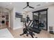 Well-equipped workout room with bike, treadmill, and view to outdoor living space at 3425 N 50Th Pl, Phoenix, AZ 85018