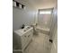 Modern bathroom featuring a white vanity and shower over tub with white tiling at 3840 N 43Rd Ave # 71, Phoenix, AZ 85031