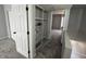 Upstairs hallway with built-in shelving, closet, and neutral carpet flooring at 3840 N 43Rd Ave # 71, Phoenix, AZ 85031