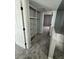 Hallway leading to carpeted bedroom with storage at 3840 N 43Rd Ave # 71, Phoenix, AZ 85031