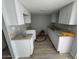 Bright kitchen featuring white cabinets, granite counters, and wood-style flooring at 3840 N 43Rd Ave # 71, Phoenix, AZ 85031