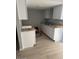 Kitchen featuring granite counters, white cabinets, and gray wood-style flooring at 3840 N 43Rd Ave # 71, Phoenix, AZ 85031