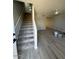 Open-concept living room with gray flooring, a staircase, and a ceiling fan at 3840 N 43Rd Ave # 71, Phoenix, AZ 85031