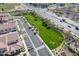 Aerial view of a large grassy area, walking path, and nearby homes in the lush, green community at 3855 S Mcqueen Rd # 101, Chandler, AZ 85286