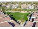 Aerial view of lush green space, sidewalks, and landscaping nestled within a beautiful community with red tiled roofs at 3855 S Mcqueen Rd # 101, Chandler, AZ 85286