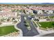 Aerial view of the community entrance, lush green grass, desert landscaping and new homes in a Primary planned community at 3855 S Mcqueen Rd # 101, Chandler, AZ 85286