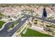 Aerial view of the community entrance, lush green grass, desert landscaping and new homes at 3855 S Mcqueen Rd # 101, Chandler, AZ 85286