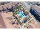 Community aerial view featuring a pristine swimming pool with desert landscaping and a Gathering enjoying the water at 3855 S Mcqueen Rd # 101, Chandler, AZ 85286