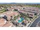 Gorgeous community aerial view featuring a pristine swimming pool with desert landscaping and neighborhood with mountain views at 3855 S Mcqueen Rd # 101, Chandler, AZ 85286