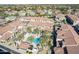 Gorgeous community aerial view featuring a pristine swimming pool with desert landscaping and neighborhood with mountain views at 3855 S Mcqueen Rd # 101, Chandler, AZ 85286