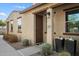 Charming home exterior featuring a well-maintained front yard and a welcoming front door with modern planters at 3855 S Mcqueen Rd # 101, Chandler, AZ 85286