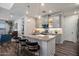 Bright kitchen features gray cabinets, granite countertops, stainless appliances, and an island with bar seating and pendant lights at 3855 S Mcqueen Rd # 101, Chandler, AZ 85286