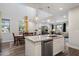 Bright kitchen with granite countertops, stainless appliances and an island with sink overlooking the dining and living area at 3855 S Mcqueen Rd # 101, Chandler, AZ 85286