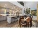 Modern kitchen features gray cabinets, granite countertops, stainless steel appliances, and an island with bar seating at 3855 S Mcqueen Rd # 101, Chandler, AZ 85286