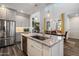 This modern kitchen has stainless appliances, granite countertops and an island with sink and room for seating at 3855 S Mcqueen Rd # 101, Chandler, AZ 85286